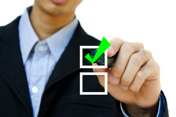 Young business hand with pen mark the check boxes.