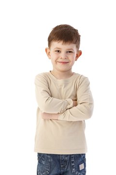 Cute little boy standing arms crossed smiling