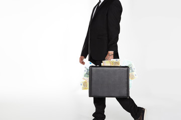 businessman carrying suitcase full of money