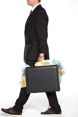 businessman carrying suitcase full of money