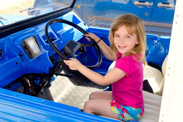 blond little girl driving in convertible