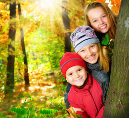 Happy Kids Having Fun in Autumn Park. Outdoors