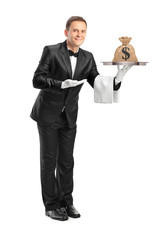 Butler holding a tray with a money bag on it