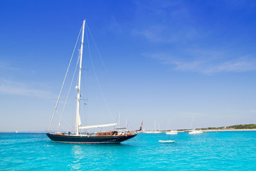 anchored sailboats in turquoise Formentera beach