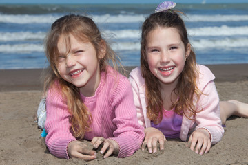 little girls playing on the beach