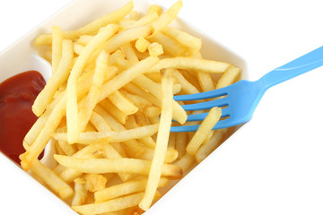 French fries with red ketchup and blue spoon on white background