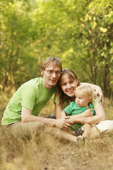 Happy family in summer forest
