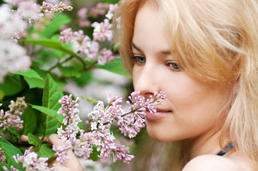 Woman with lilac flower on face