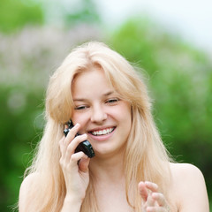 Young woman using phone at park