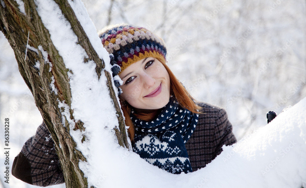 Sticker beautiful young red-haired woman in winter park