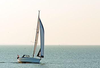 Naklejka premium Sailboat on a lake at sunset, Holland