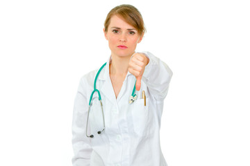 Fototapeta premium Serious medical doctor woman showing thumbs down