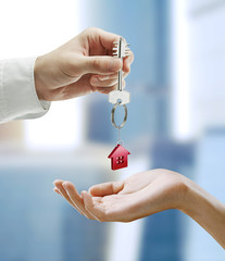 Man is handing a house key to a woman
