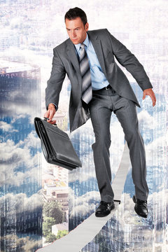 businessman walking a slackline