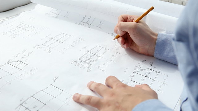 engineer checks the construction drawings