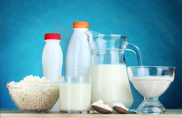 Dairy products on wooden table on blue background