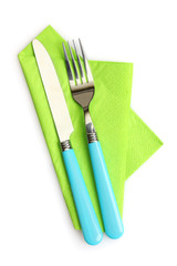 knife and fork on a napkin isolated on white