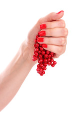 beautiful red manicure and pearls isolated on white