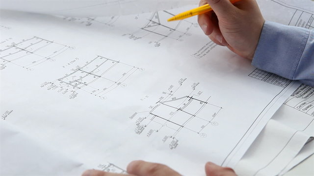engineer checks the construction drawings