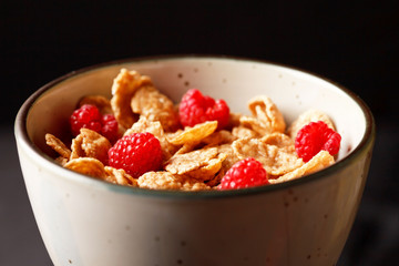 Cornflakes with milk and raspberries