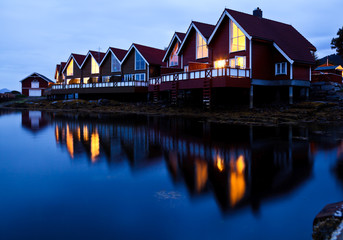 Camping cabins on a fjord at night