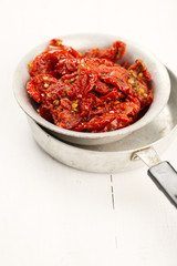 sun-dried tomatoes with olive oil in an old tinware