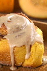 Pumpkin cinnamon roll with cinnamon icing on top