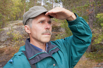 An elderly traveller looking into the distance