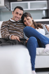 Relaxed young  couple watching tv at home