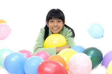 Fototapeta na wymiar young girl playing in balloons