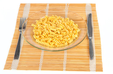 Macaroni in a transparent plate on straw mat