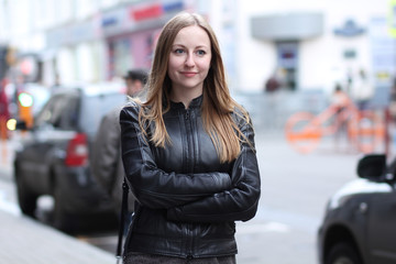 Beautiful young woman in a black leather jacket