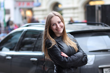 Beautiful young woman in a black leather jacket