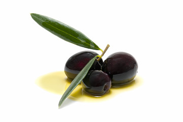 three fresh olives bathed in olive oil