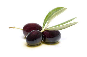 three fresh olives bathed in olive oil
