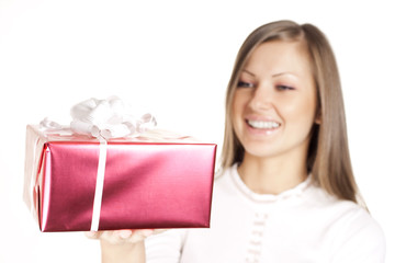 beautiful young smiling woman holding christmas gift