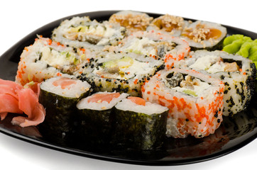 Set of japanese sushi rolls on black plate
