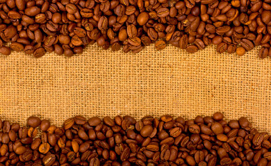 Coffee grains on the burlap background