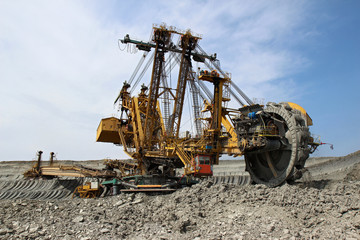 huge yellow overbuden excavator in brown coal mine