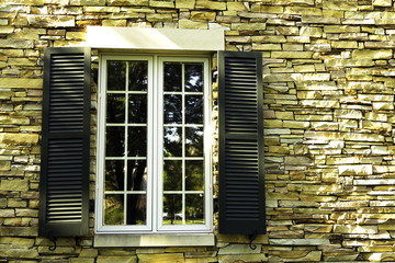 Window in a stone wall with shutters