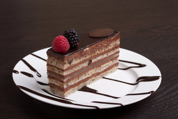 Slice of chocolate cake on a white plate.