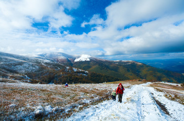 Fototapeta premium Family on autumn mountain plateau first winter snow