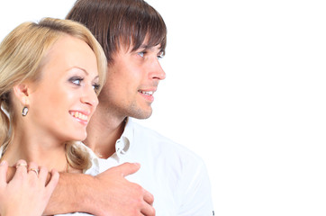 Couple having embraced look afar on a white