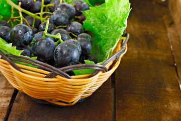 Basket of grapes on rustic wooden table