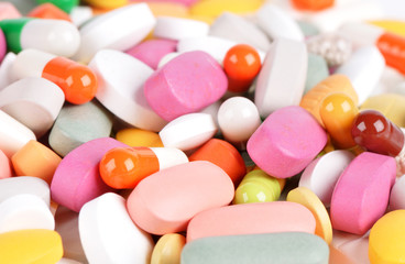 Stack of different pills isolated on white background