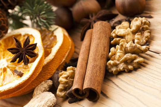 Different kinds of spices, nuts and dried oranges - christmas de