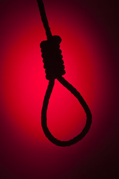 Silhouetted Hangman's Noose Over Red Background