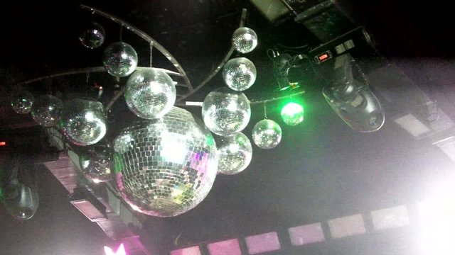 Mirror balls are in the nightclub at the disco