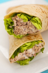 Two tuna melt wrap on a white plate
