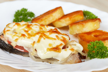 Salmon baked under vegetables and mayonnaise